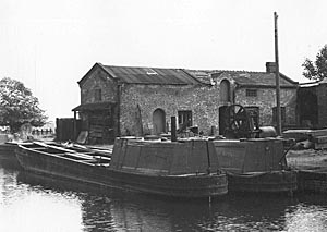 Working boats moored outside the Repair Works on the Trent & Mersey Canal at Alrewas